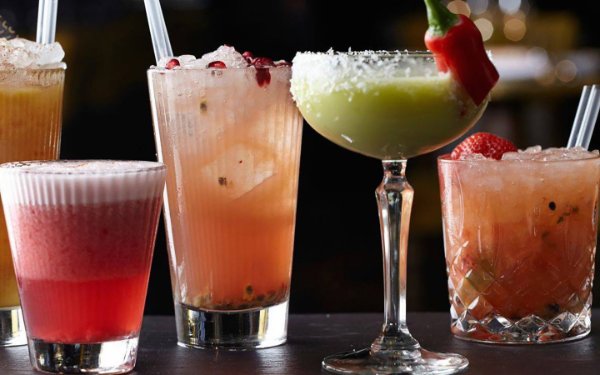 Four different colorful  cocktails on display