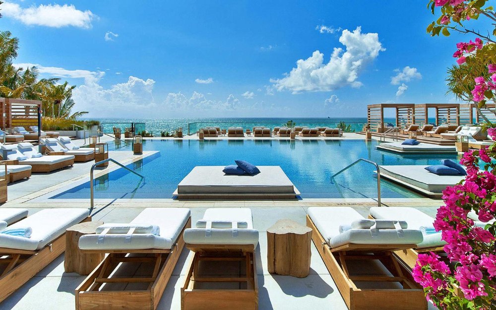 Pool deck at 1 Hotel South Beach showing luxury lounge chairs with an ocean view