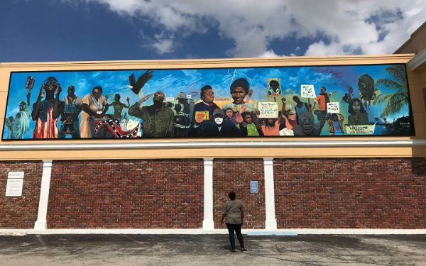 Mural on the side of OneUnited Bank building by Addonis Parker