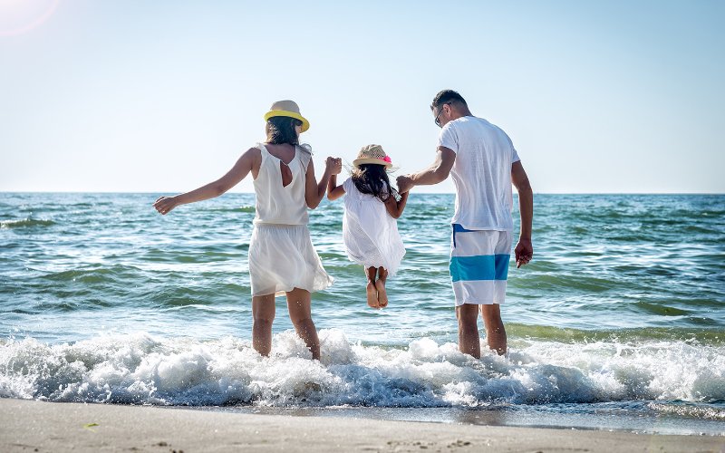 Family walking in the surf on Miami Beach