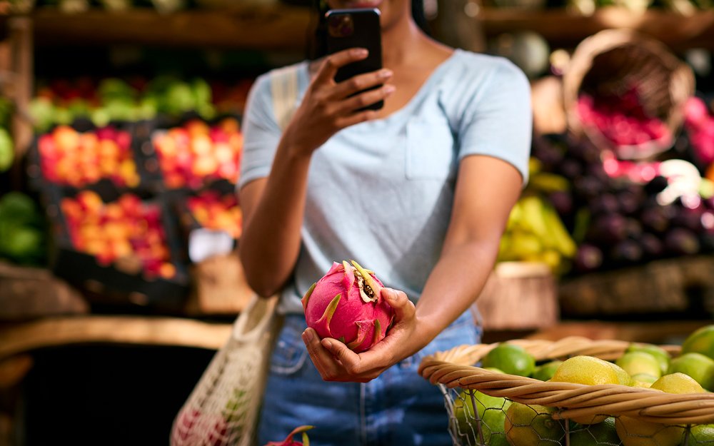 Visitor snaps a picture of Dragon Fruit at local farmer's market