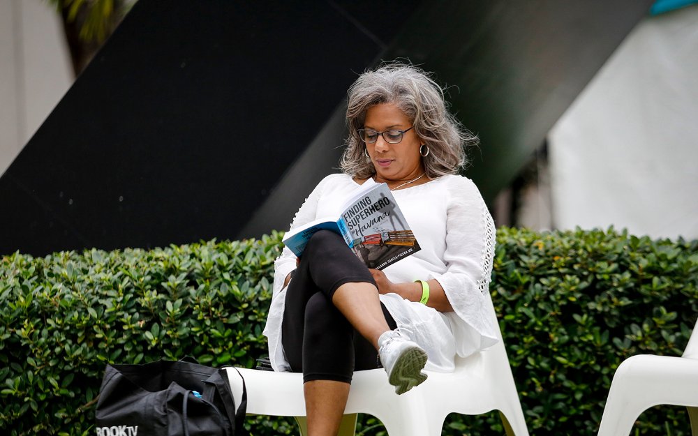 Woman reading at Miami Book Fair